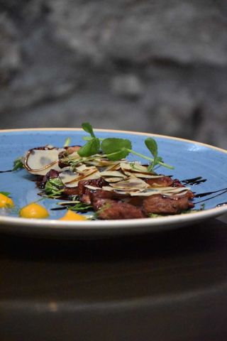 Chicken tagliata in Teran sauce, rocket salad, Grana Padano