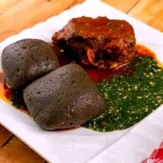 Amala served with ewedu mixed with egusi and goatmeat 