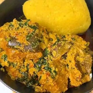 Egusi mixed with Assorted served with yellow Eba 