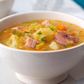 Homemade Soup Served With Crusty Roll