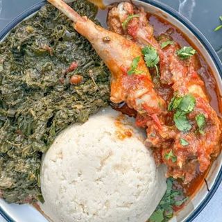 White ugali served with kuku kienyeji and managu veges