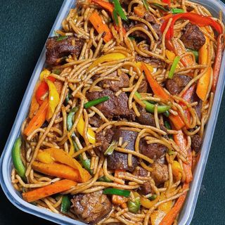 Jollof spaghetti with full chicken lap