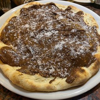 Pizza De  chocolate y coco rallado