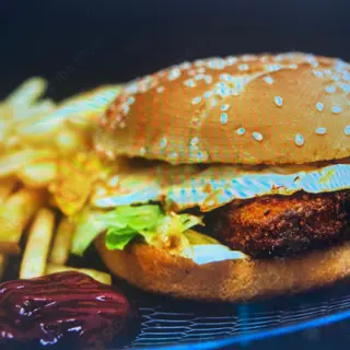 Hamburgesa de merluza empanada con papas fritas