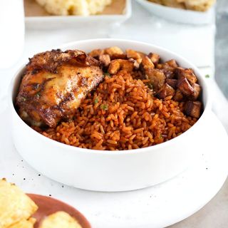 Jollof rice with fried plantain, salad and beef