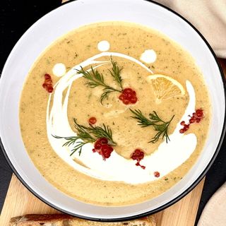 Salmon cream soup with leek and red caviar