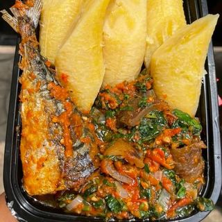 Boiled plantains served with Titus fish mixed with pomo and and vegetables 
