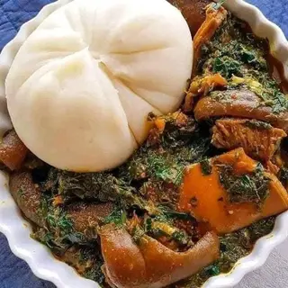 Pounded yam served with eforiro mixed with pomo and shaki