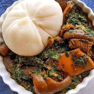 Pounded yam served with eforiro mixed with pomo and shaki
