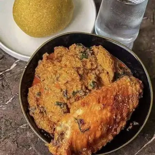 Yellow Eba served with egusi and turkey 