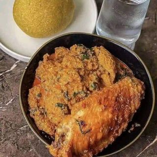Yellow Eba served with egusi and turkey 