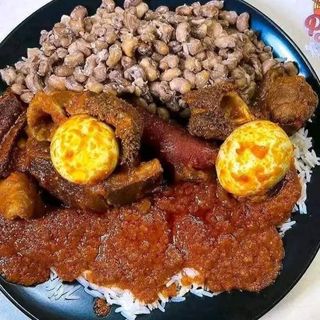 Nigerian beans, white rice, shaki mixed with pomo andboiled eggs