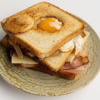 Sándwich Especial. Bacon, Huevo, Queso Semicurado y Cebolla Pochada