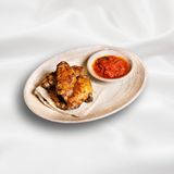 Chicken wings with ajika and vegetables