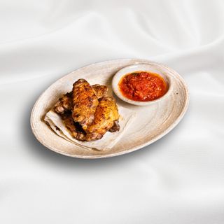 Chicken wings with ajika and vegetables