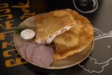 Cheburek with ham and cheese and garlic sauce.