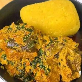 Yellow Eba served with egusi mixed with assorted 