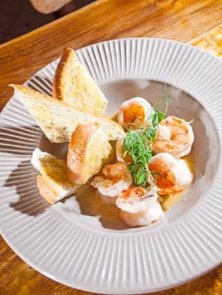 Скариди в маслен сос и перно Рикар, поднесени с кростини от хляб, приготвен в Padre (150г)