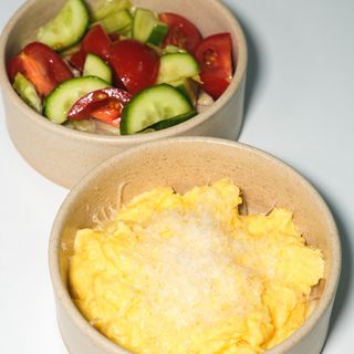 Creamy scrambled eggs with fresh salad