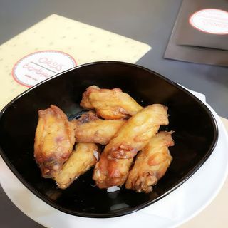 Alitas de pollo fritas con patatas paja y salsa barbacoa