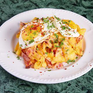 Sunny side up eggs with french fries, bacon, garlic & cheddar cheese