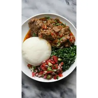 Wet fried goats meat with posho and greens