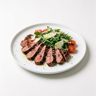 La Tagliata de buey con parmesano e rúcula