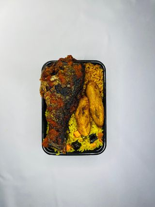 A Plate Of Rice With Croaker