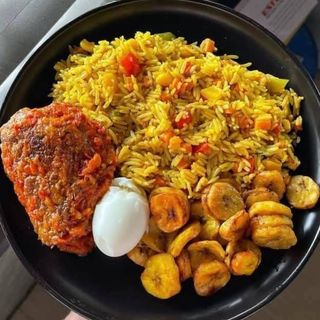 Jollof rice, plantains, turkey and boiled egg