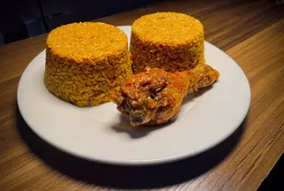 2 Spoons Of Jollof Rice + 1 Chicken Drumstick