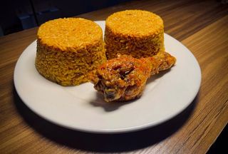 2 Spoons Of Jollof Rice + 1 Chicken Drumstick