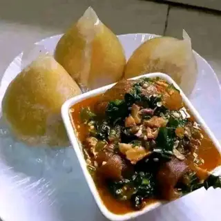 Yellow Eba served with assorted goatmeat mixed with eforiro vegetables 