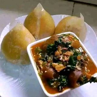 Yellow Eba served with assorted goatmeat mixed with eforiro vegetables 