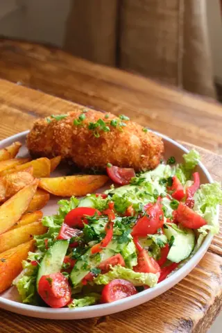 Chicken kiev with Mexican potatoes and salad