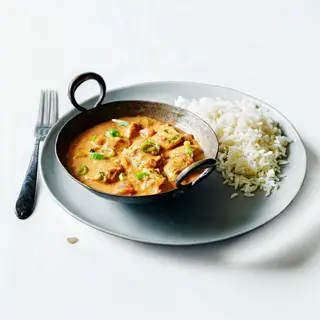 Chicken curry served with vegetable rice or chapati