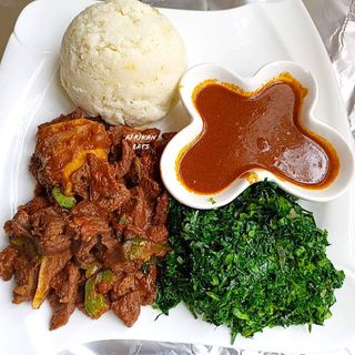 Sima (Ugali)  with beef steak wet fry and  greens