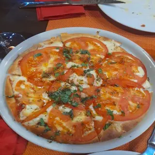 Pizza media masa grande jamón y tomate