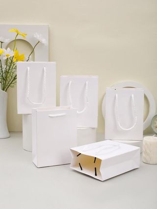 Sac cadeau blanc avec poignées