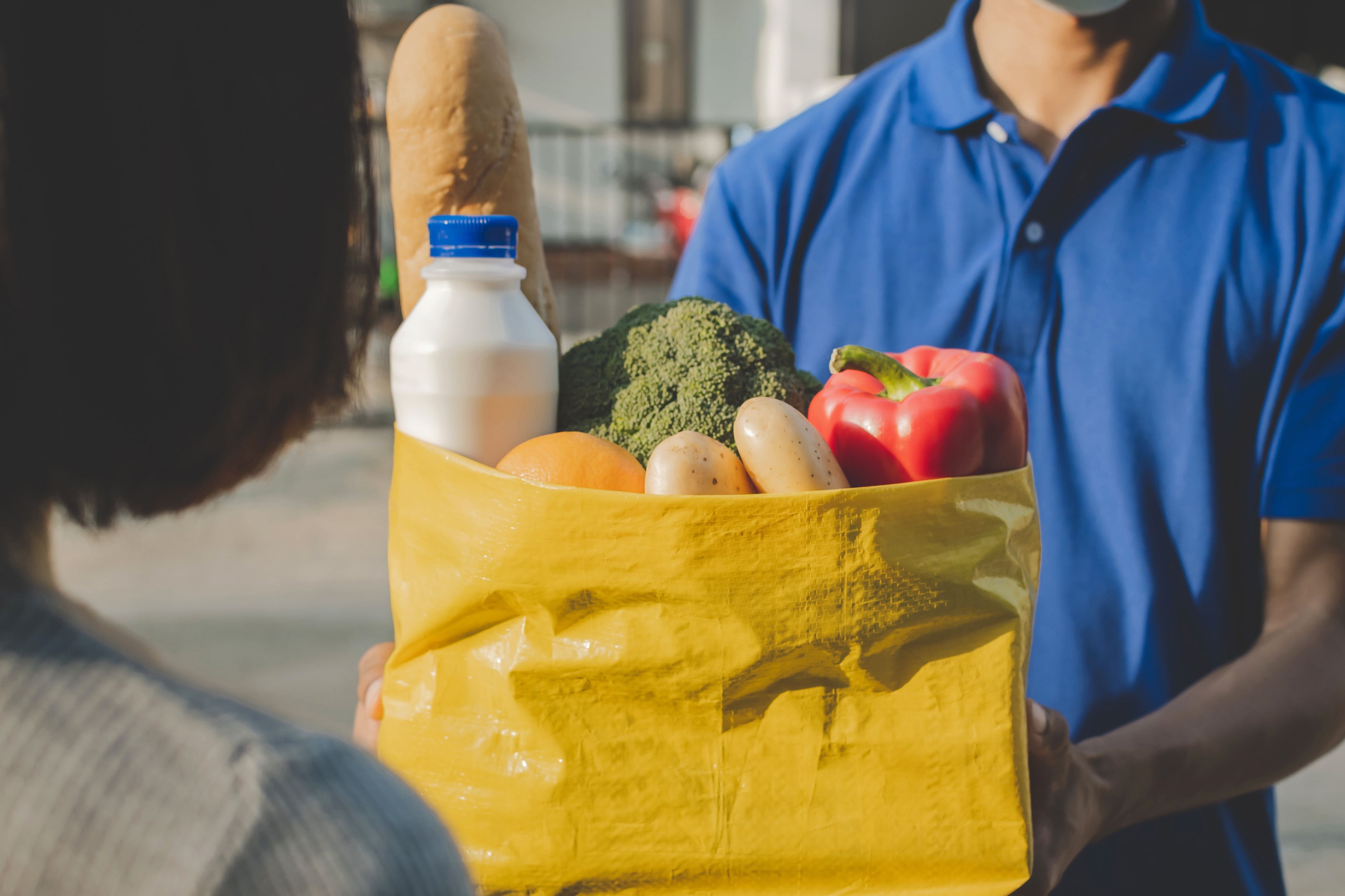 Man delivers bag full of groceries