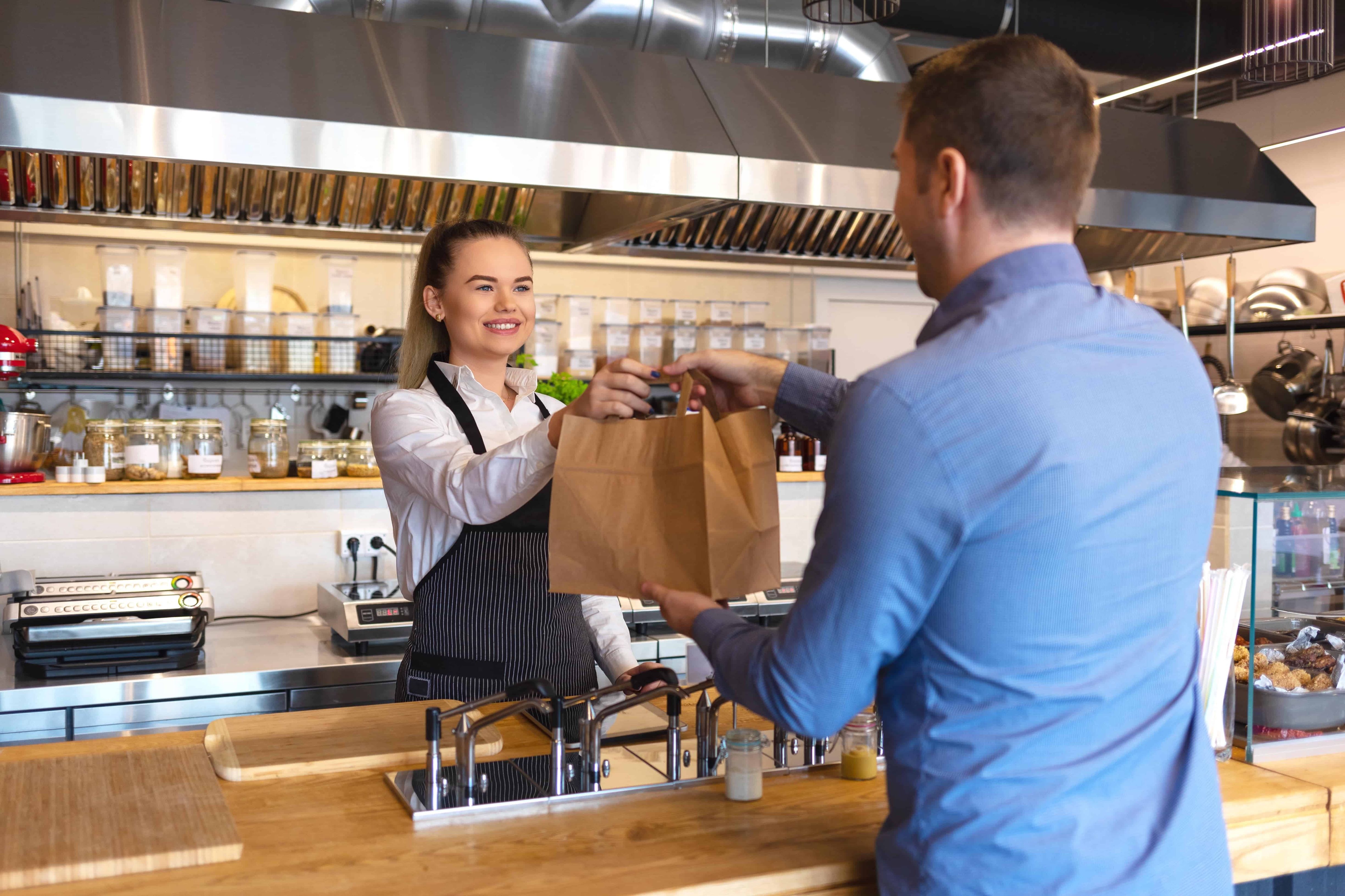 A customer is handed their order over the counter