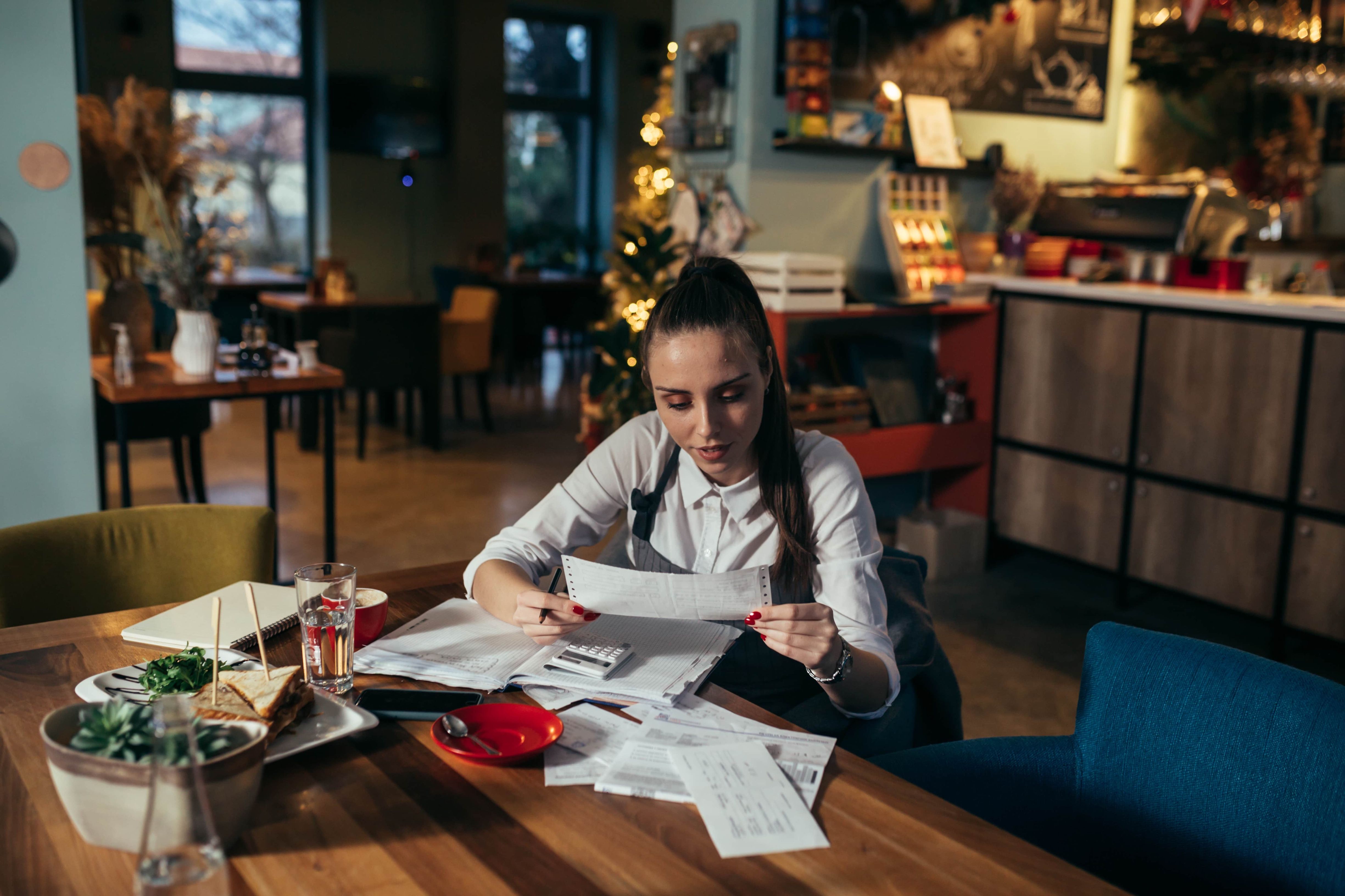 Two restaurant employees using a laptop