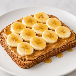 Tostada De Crema De Cacahuete + Plátano Y Miel